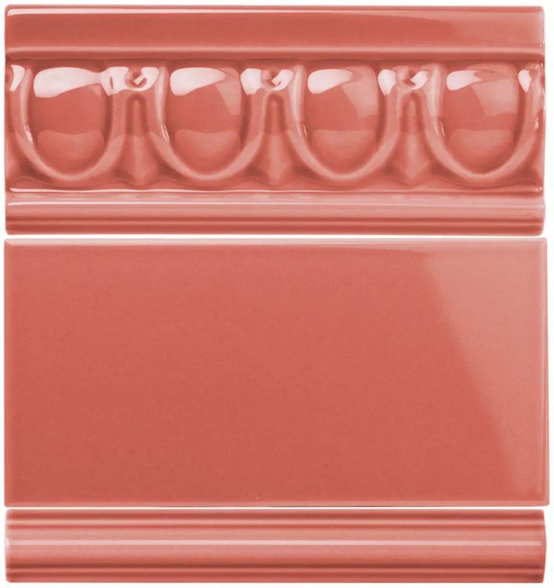 Coral-colored ceramic tile with a glossy finish and decorative molded border.