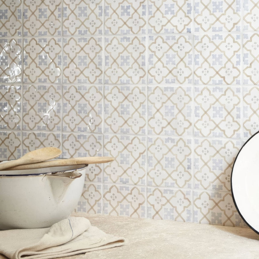 White ceramic mixing bowl with chipped rim and wooden spoons resting on top for cordoba decor 3 hand painted tile