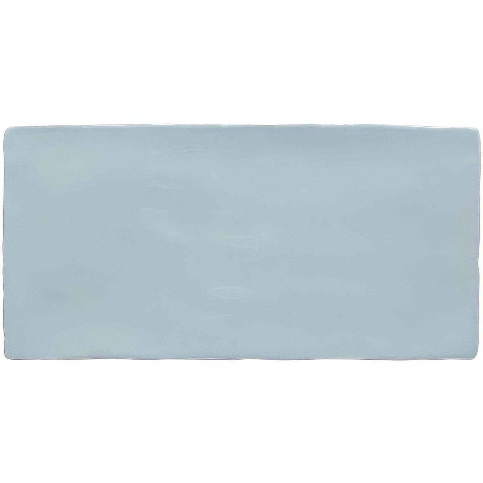 A rectangular matte-finished light blue ceramic cornflower brick wall tile with slightly rounded edges 20x10cm