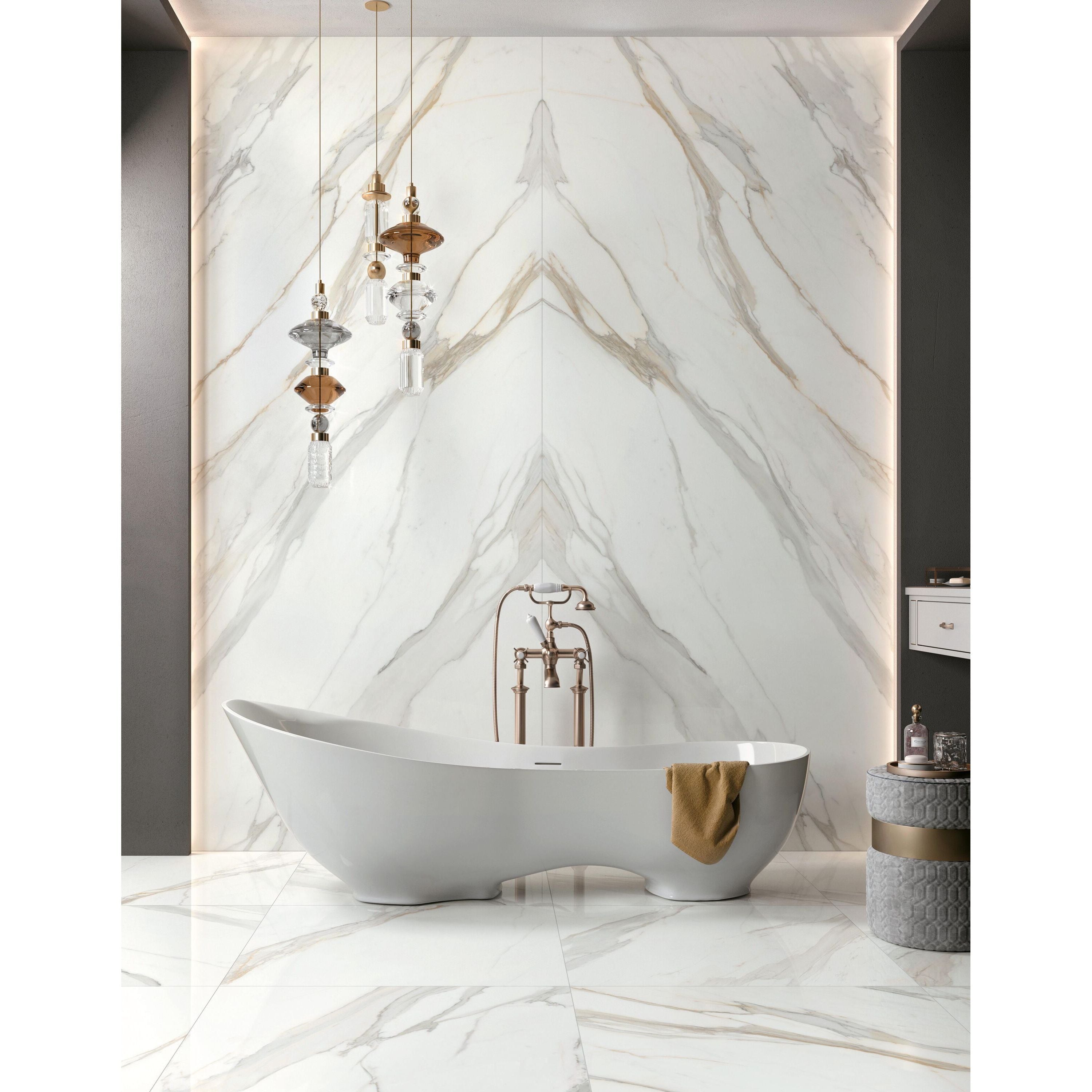 White freestanding bathtub with copper fixtures and gold towel next to cosmopolitan calacatta gold lappato 80 x 80cm tile