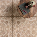 Beige and taupe geometric patterned floor tiles with floral motifs cotele taupe on chalk for indoor flooring
