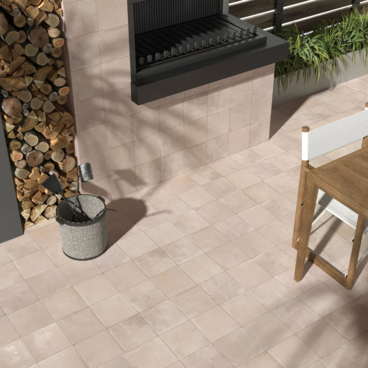 Gray woven metal fire tool bucket displayed with cotto blanc terracotta effect tiles background