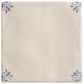 Cream-colored ceramic tile country delft ada with delicate blue floral motifs in each corner