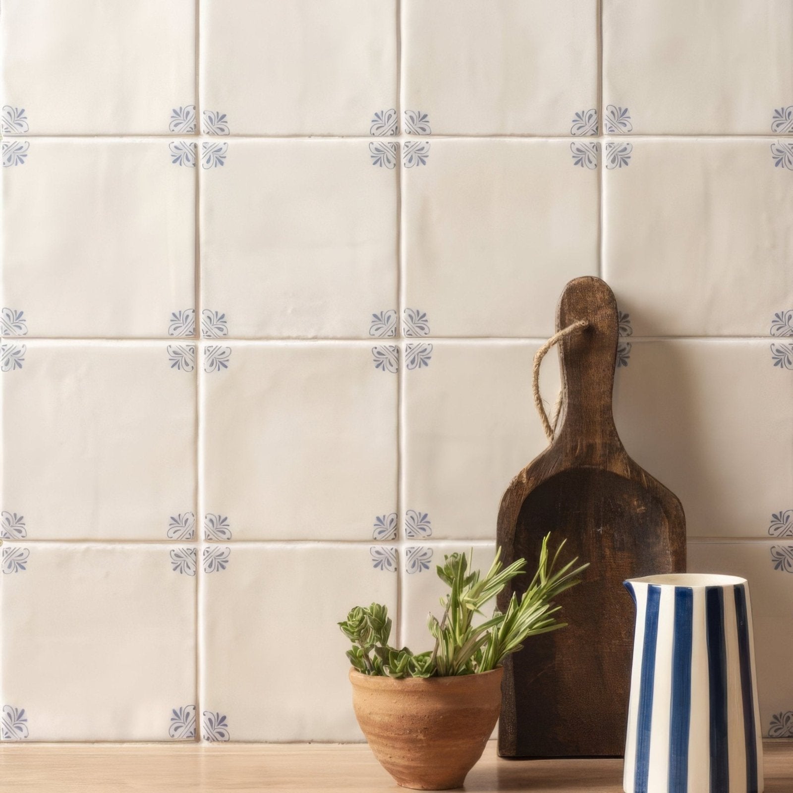 Cream-colored ceramic tiles with subtle blue floral motifs in a grid pattern country delft beatrix design