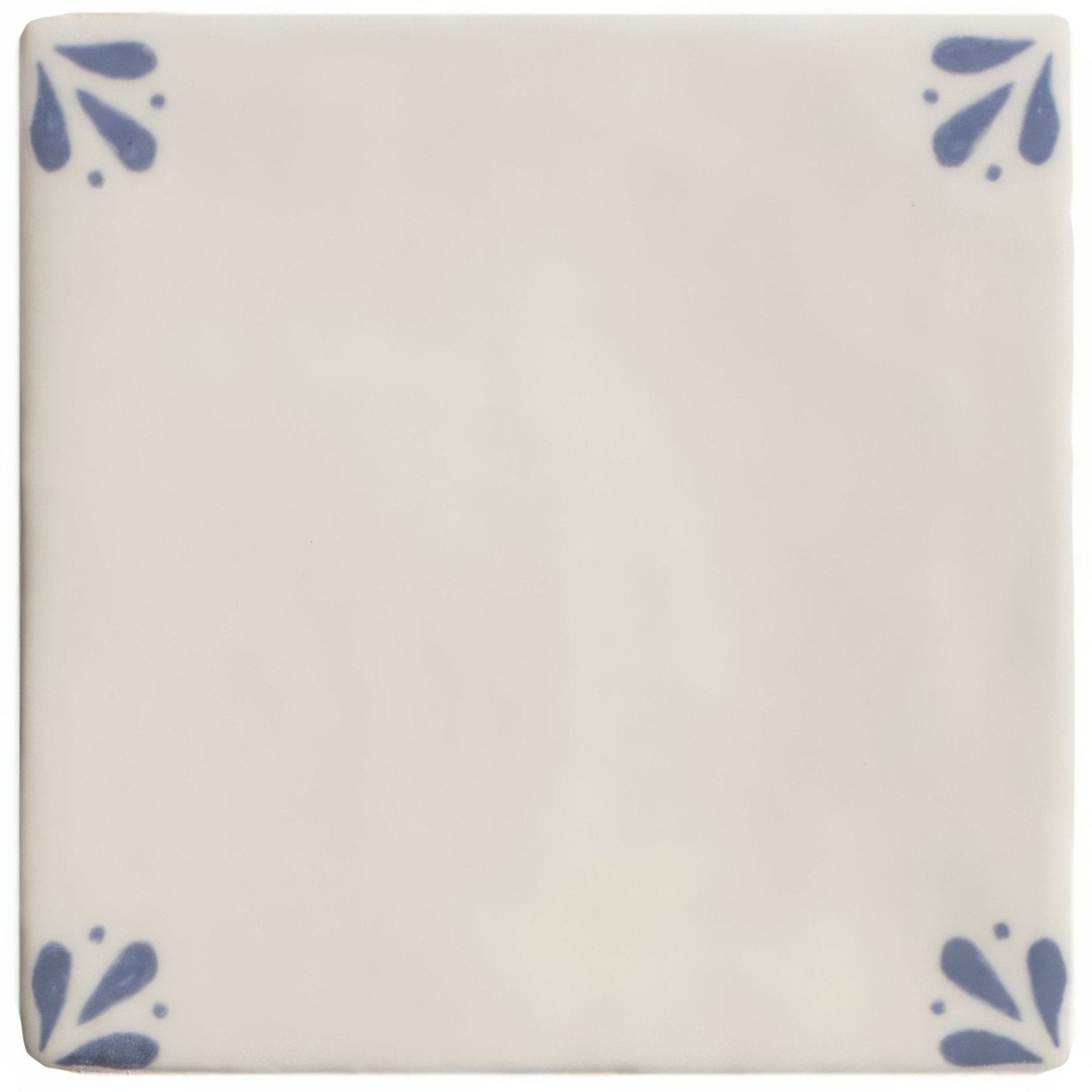 Cream-colored ceramic tile country delft cornelia with delicate blue floral motifs in each corner