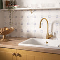 Gold-finished kitchen faucet country delft cornelia with curved spout and white ceramic handle for country style kitchens