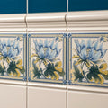 Blue and yellow floral patterned ceramic tiles with ornate borders from the County White Albert moulding collection