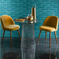 Modern glass-top table with sleek black wireframe base showcasing cove brick tile surface design