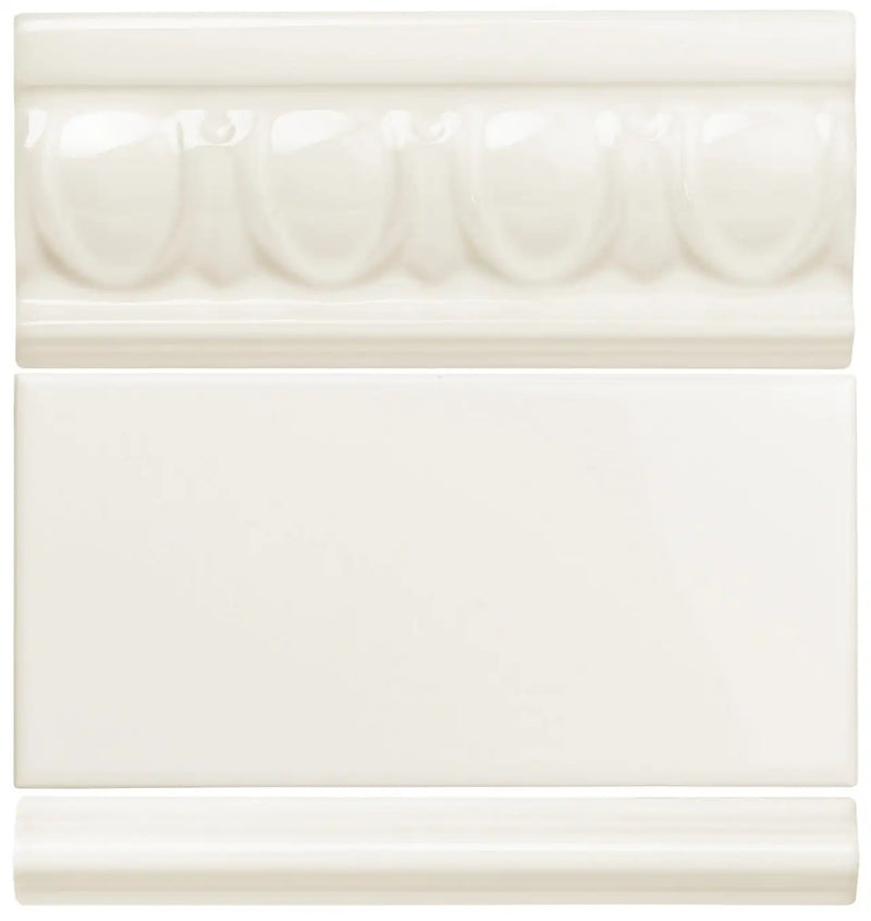 Cream-colored ceramic tile with a decorative, raised oval pattern along its top edge.