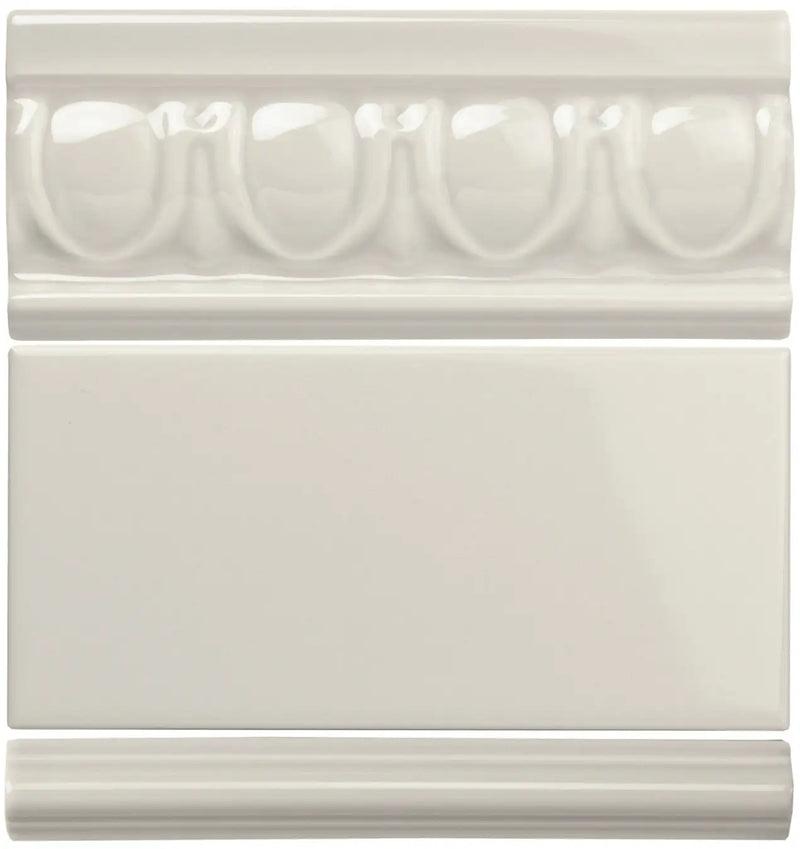 Cream-colored ceramic tile set featuring an ornate, raised bead pattern on the top piece and a smooth rectangular surface.