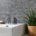 Crypto Small Hexagon Honed Marble Mosaic dark grey marble hexagon mosaic behind a white vessel sink with a chrome tap