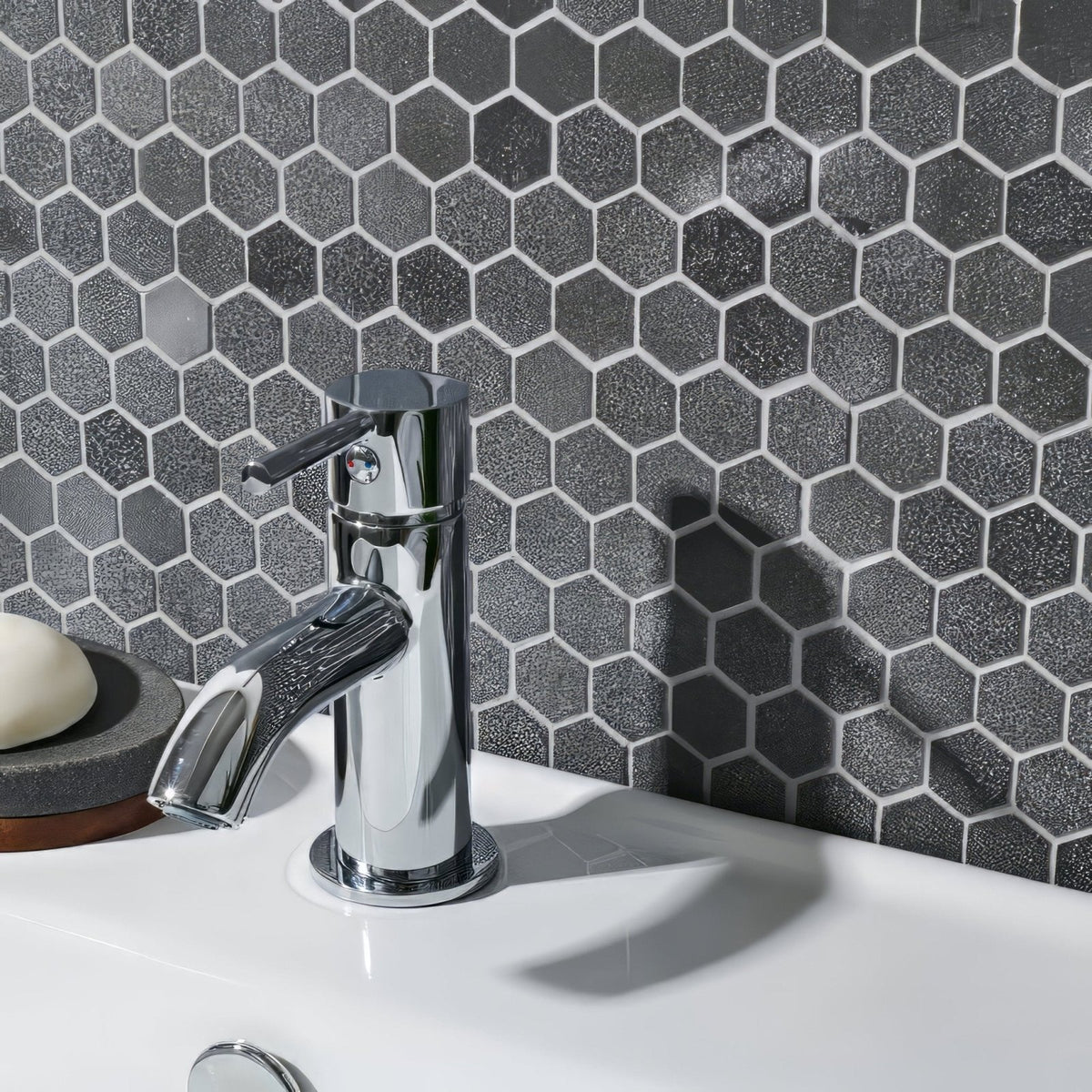 Crypto Small Hexagon Honed Marble Mosaic dark grey marble hexagon mosaic behind a chrome bathroom tap