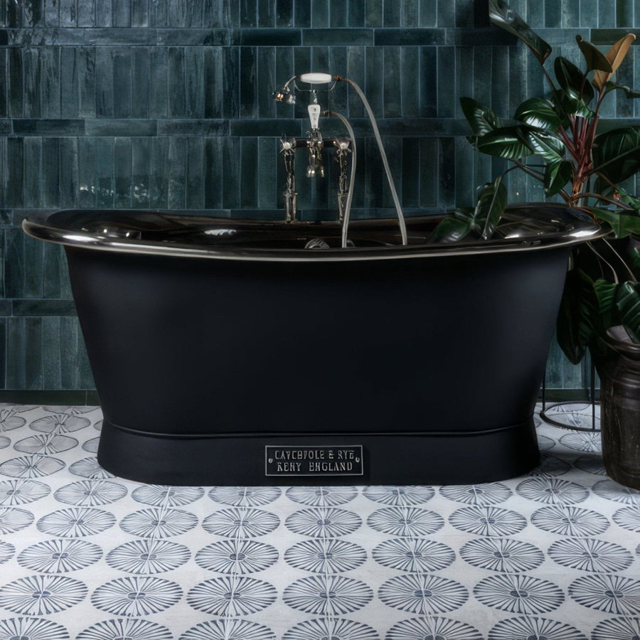 Black matte freestanding porcelain bathtub with polished chrome fixtures and cayebole style plaque from Cuba Infantas Blue