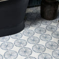 White ceramic floor tiles with dark gray sunburst motifs from cuba porcelain infantas blue collection