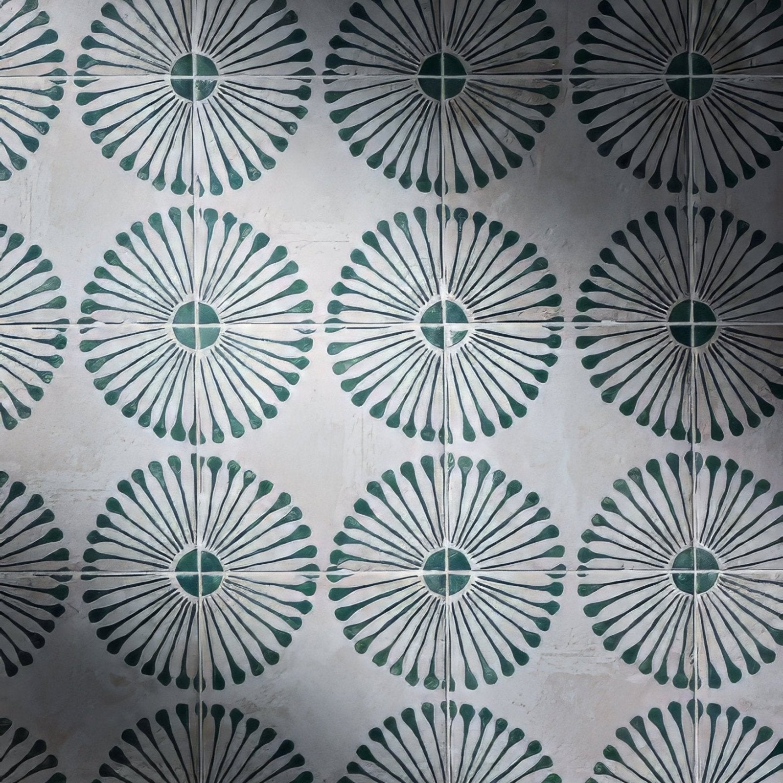 White porcelain tiles with a repeating dark green floral petal pattern from cuba porcelain infantas green collection