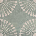 A square ceramic porcelain tile with a muted mint green base and distressed white teardrop pattern called cuba porcelain vedado mint green