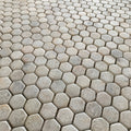 Full Calacatta Sugar hexagon mosaic sheet showing gold and grey veins arriving in fragments across the pieces