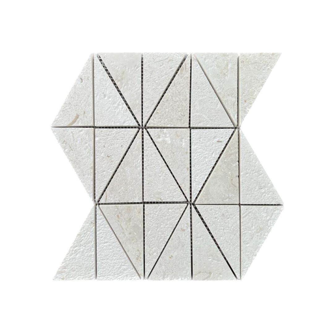 Close detail of brushed Shellstone limestone triangle mosaic pieces showing cream tone and textured surface