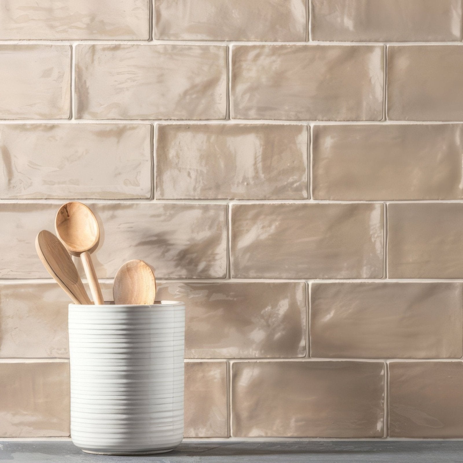 White ribbed ceramic utensil holder with wooden spoons shown with damask brick wall tile 20x10cm background