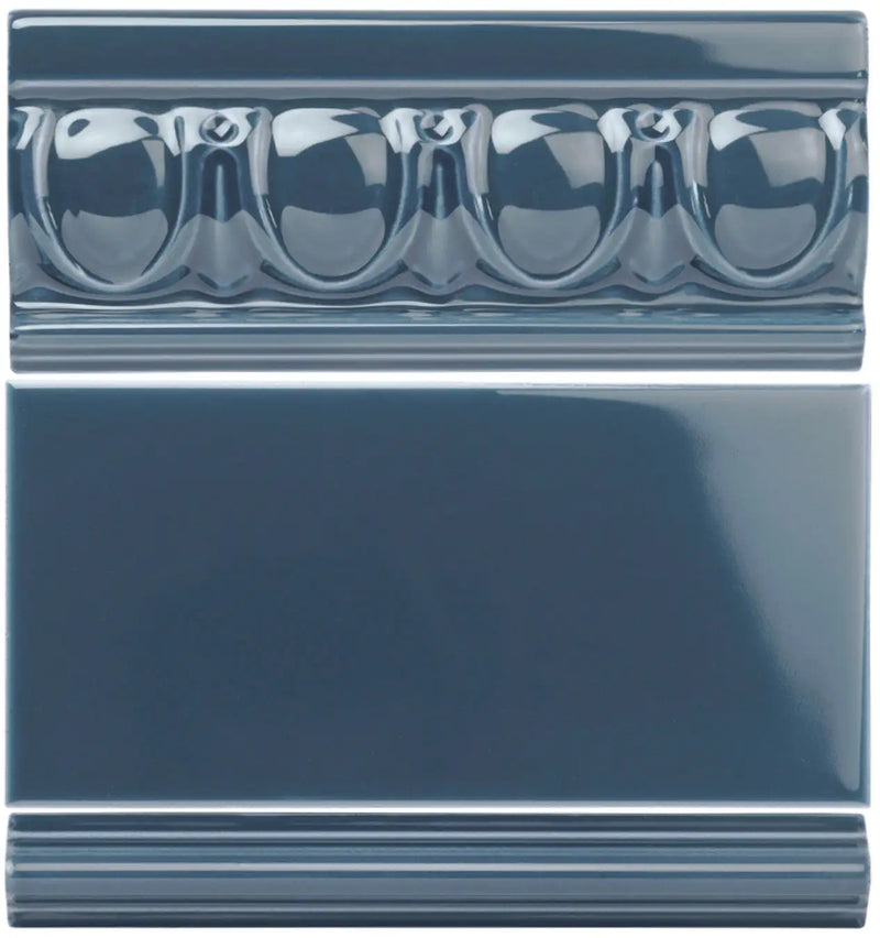 Dark blue glossy ceramic tile with a decorative molded bead pattern along the top edge.