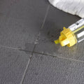 Transparent water bottle with bright yellow screw-on cap and handle featuring bows logo alongside dark grey tetra quarry tiles 300x300x9mm