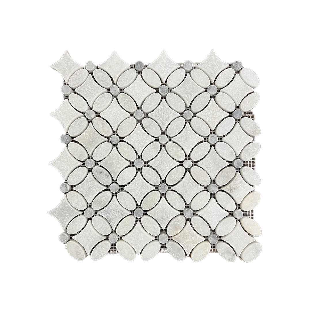 Close detail of the tumbled marble flower motif showing softened petal edges in white and platinum grey