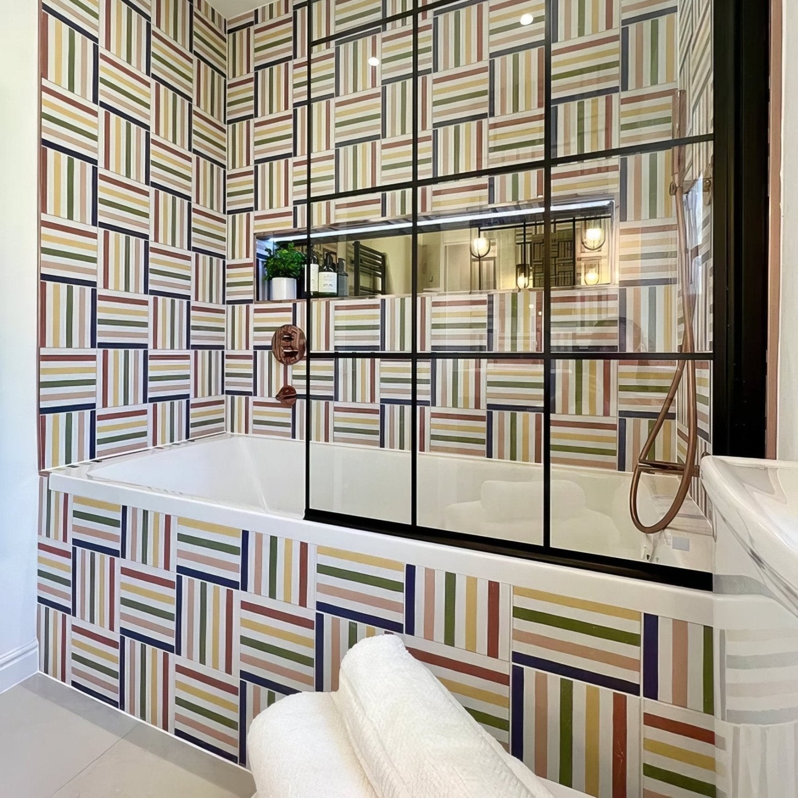 Deck chair porcelain rainbow with a white sleek modern bathtub and glass shower enclosure framed by black metal
