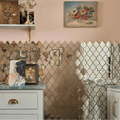 The wall features a deco glass bell silver mosaic with reflective gold and silver quatrefoil mirror tiles