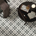 Black marble coffee table with glossy finish and dark wooden legs featuring Decorata 03 patterned 15 x 15cm tile