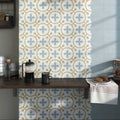 Decorata 07 patterned ceramic tile with light blue and gold geometric design on white 15 x 15 cm surface