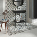 Black vanity sink with white ceramic basin and chrome faucet on black metal stand with lower shelf featuring Decorata 09 tile