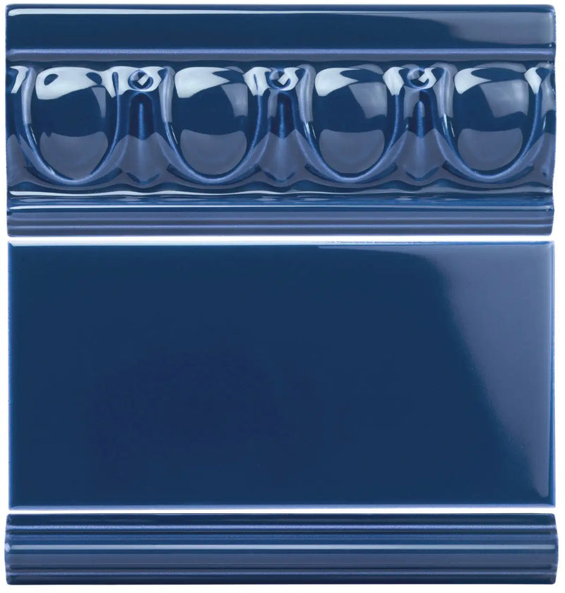 Deep blue ceramic tile with a glossy finish and decorative molded bead pattern along the top edge.