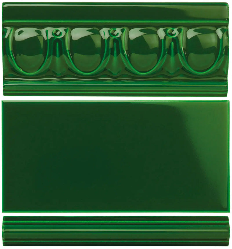Deep emerald green ceramic tile with a glossy finish and decorative molded edges.