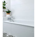 Delicate Wall Ceramic 33.3 x 55cm glossy white tiles with a bathtub and chrome fixtures