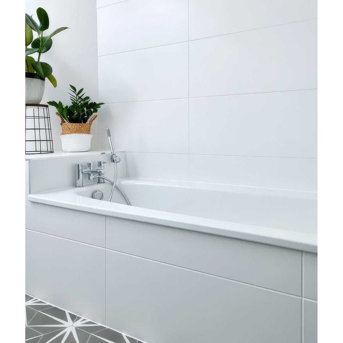Delicate Wall Ceramic 33.3 x 55cm glossy white tiles with a bathtub and chrome fixtures