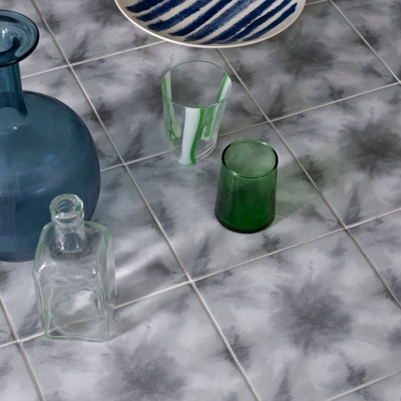 Translucent blue glass vase with ribbed texture and flared neck from Designers Guild Shibori Graphite collection