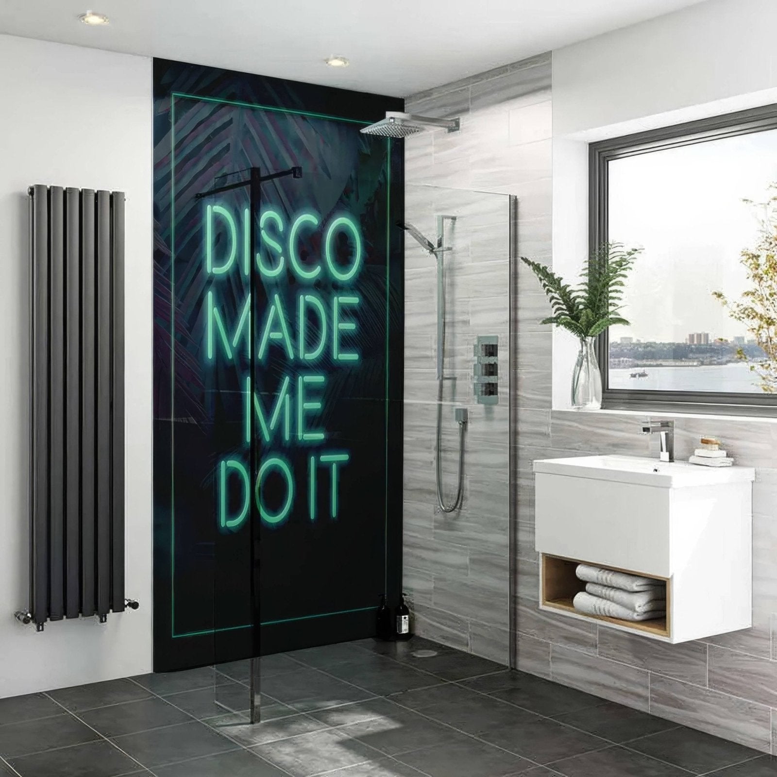 A sleek black disco typography shower panel with a glowing teal neon sign on a dark leaf-patterned backdrop