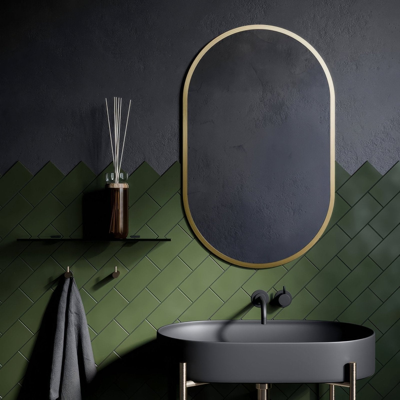 Oval docklands capsule mirror with sleek brushed brass frame and dark gray reflective surface for stylish decor