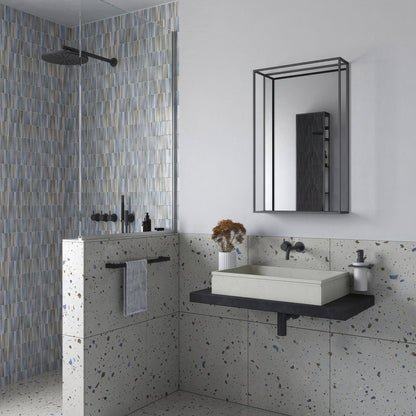Modern white rectangular sink with black countertop and faucet against speckled gray terrazzo walls with docklands mirror with shelf 50x80cm in black