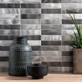 Dreadnought Brushed Aluminium Mosaic grey and silver metallic mosaic with a black patterned vase