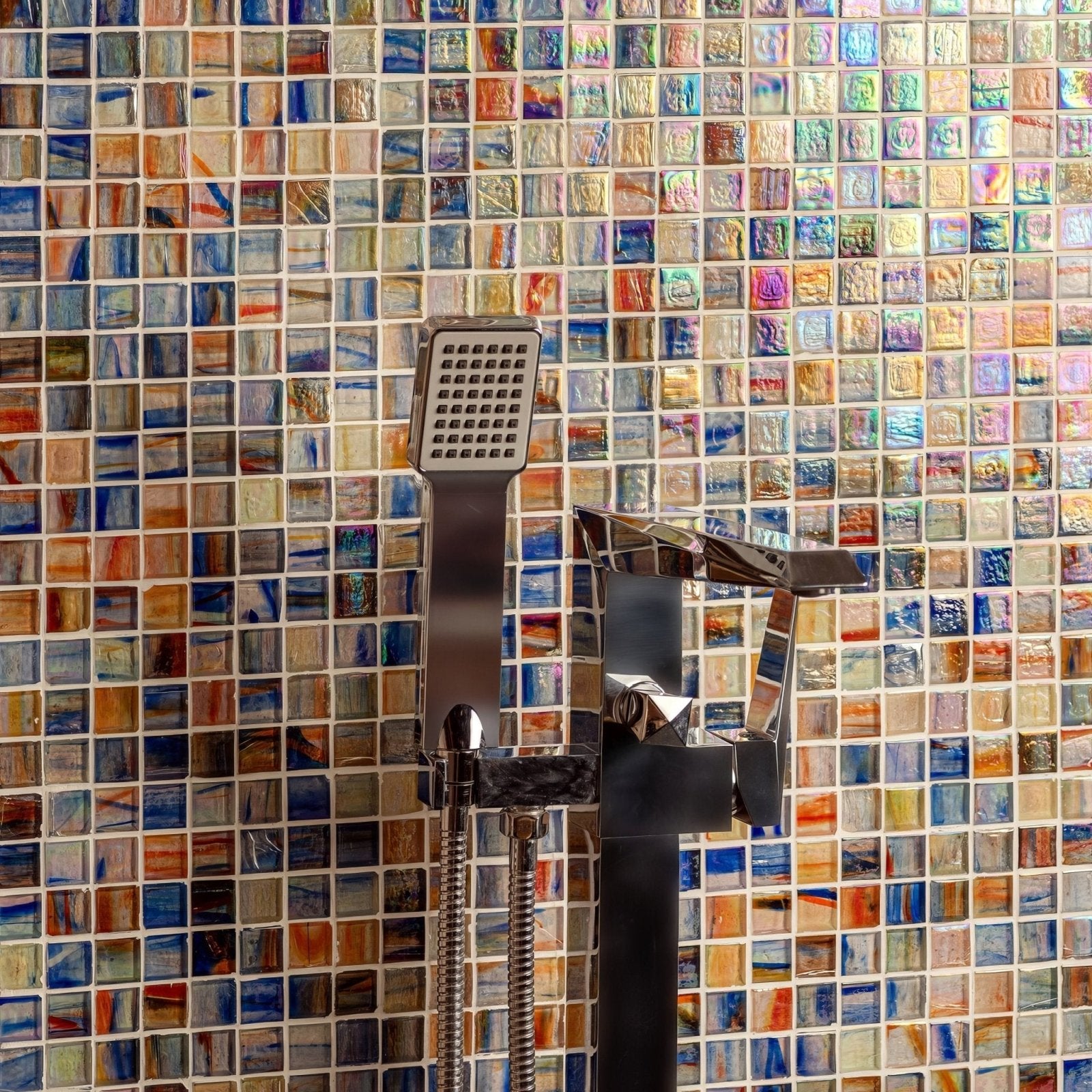 Dream Film Faced Mosaic 25mm iridescent glass mosaic in a shower with a chrome showerhead and tap