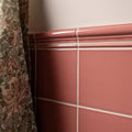 Pink ceramic tile duchy pink omega moulding with glossy finish and decorative molding along the top edge