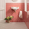 White ceramic duchy pink victoria moulding wall-mounted sink with gold-finished faucets and plumbing
