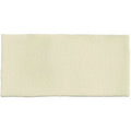 Cream-colored half tile dune bath mat with subtle textured surface for bathroom use