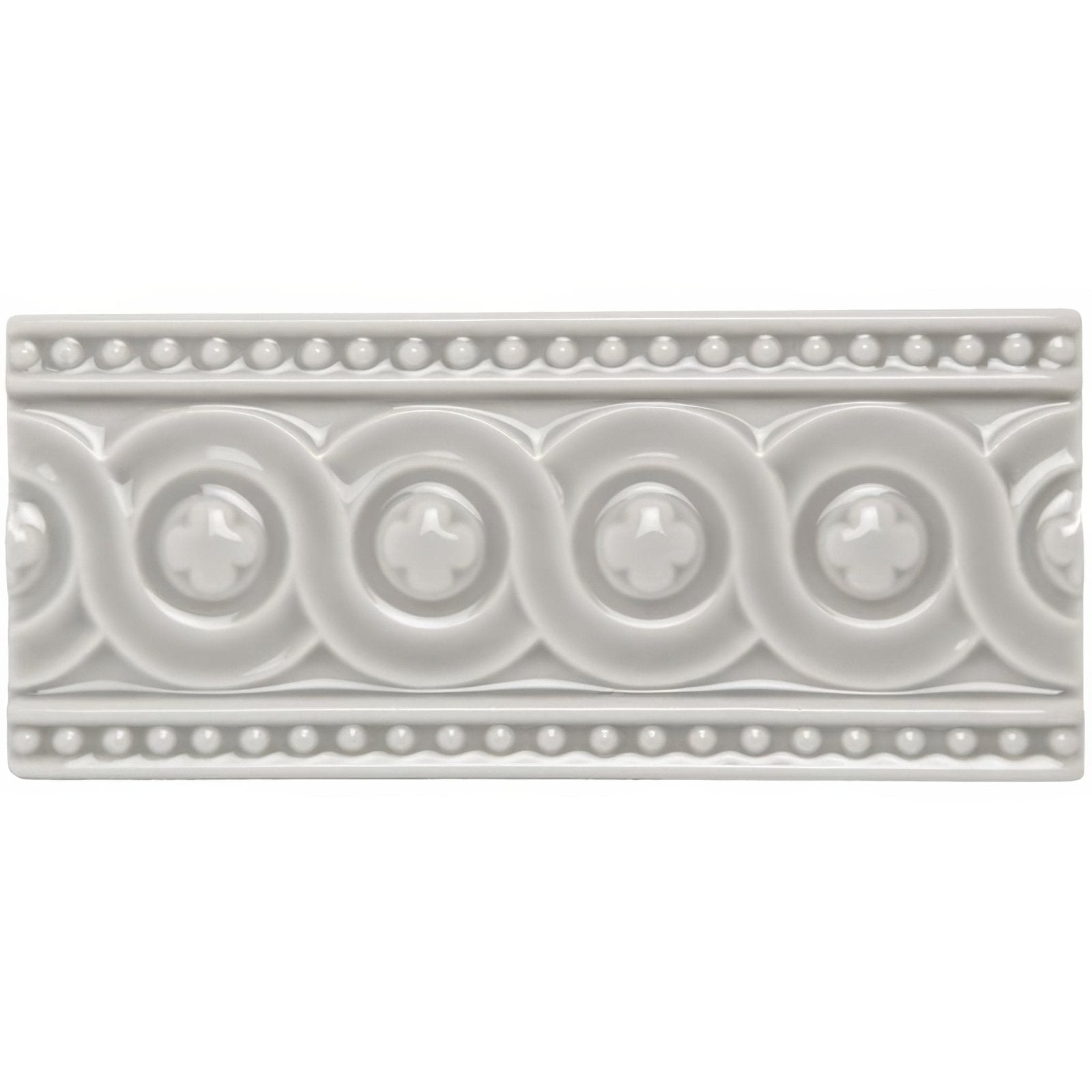 A rectangular off-white ceramic tile dunwich baroque with raised circular motifs and beaded borders pattern