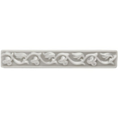 Dunwich Beaulieu white ceramic tile with ornate raised floral and vine pattern along its length