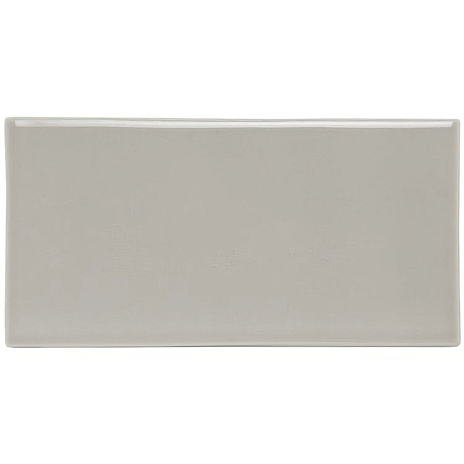 A sleek rectangular dunwich half tile made of ceramic with a smooth matte gray finish and rounded edges