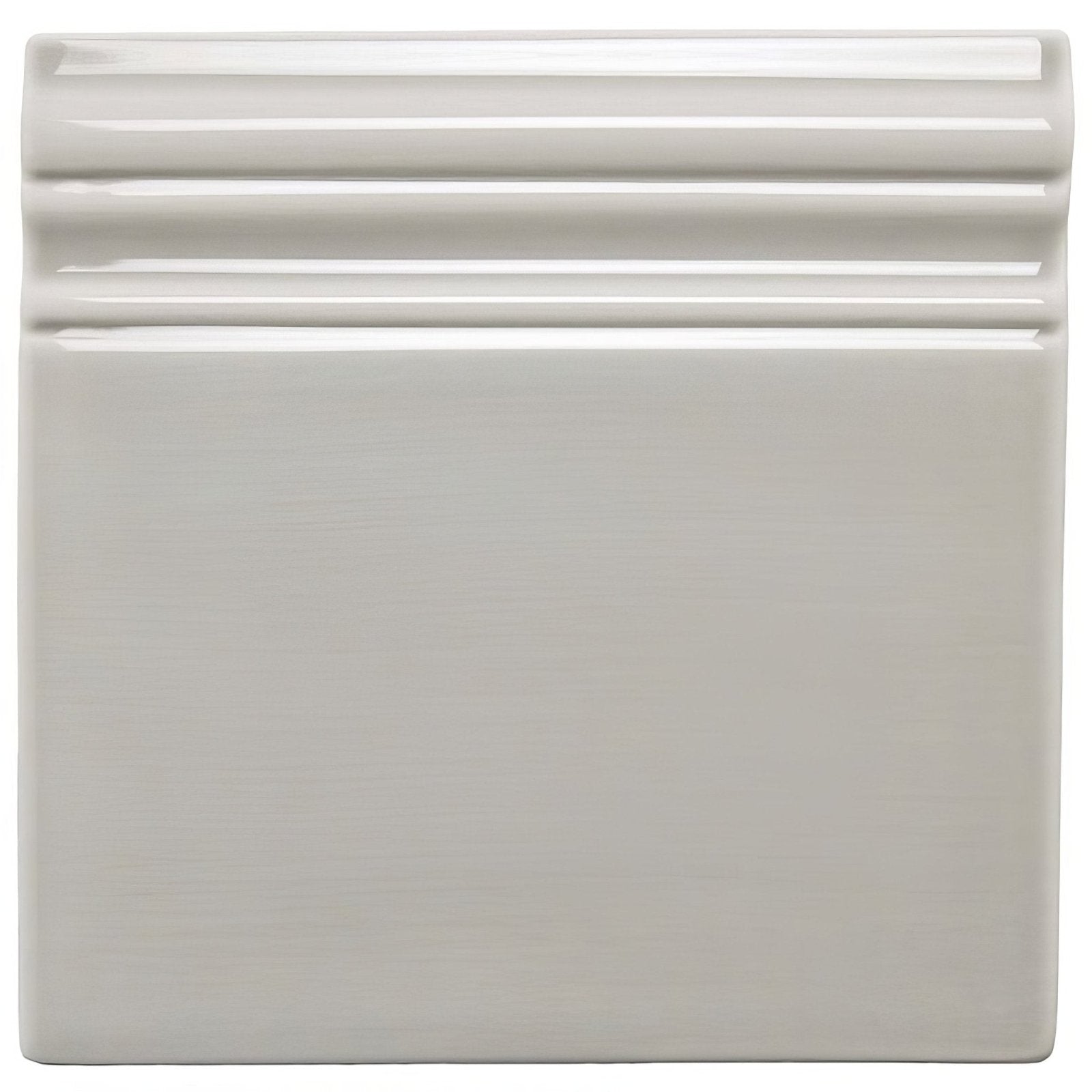 Cream-colored dunwich skirting ceramic tile with a smooth glossy finish and three horizontal ridges along the top edge