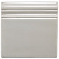 Cream-colored dunwich skirting ceramic tile with a smooth glossy finish and three horizontal ridges along the top edge