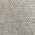 Close view of tumbled Calacatta Sugar hexagons showing worn rounded edges and a lightly pitted matt face